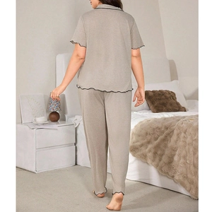 Women's pajama set featuring short sleeve top and long pants with black ruffle trim
