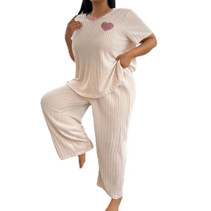 Women's cream rib-knit pajama set with pink heart pattern and lace trim details