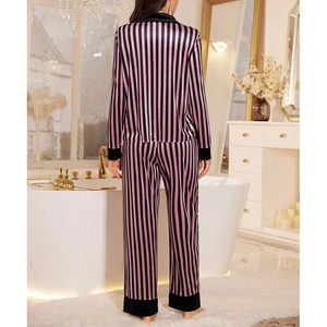 Women's pink striped velvet pajama set featuring long sleeves and cozy pants in luxury bath
