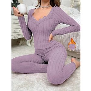 Detail of purple ribbed thermal loungewear set featuring delicate V-neck lace trim