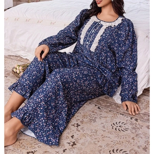 Detail view of floral pajama set featuring delicate white lace trim on sleeves and hemline