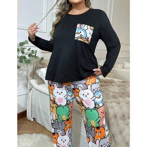 Detail of plus size pajama set showing cartoon pocket and printed pants in bedroom setting