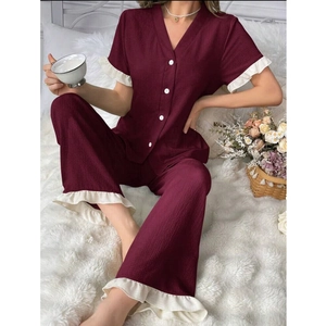 Detail view of burgundy V-neck pajama set with white ruffle trim and button closure