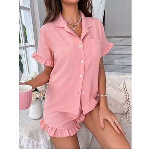 Pink short sleeve pajama set with ruffled edges and button-up shirt for home wear