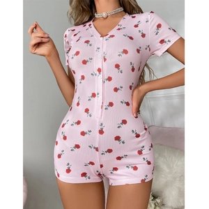 Close-up of pink ribbed knit romper featuring red rose floral print and V-neckline buttoning