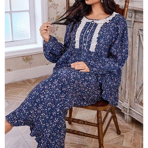 Detail of floral sleepwear featuring lace ruffles and buttons on a blue vintage nightdress