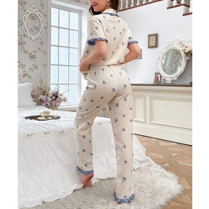 Detail of floral pajama set back view showing blue wavy trim and bubble fabric texture