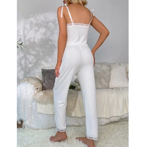 White ribbed pajama set with lace trim and satin bow straps for a comfortable fit