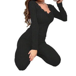 Women's two-piece black rib-knit lounge set with elegant lace V-neck and long pants