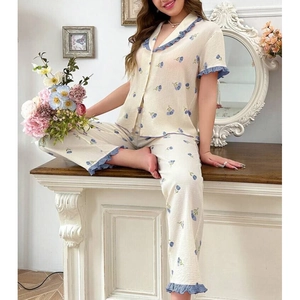 Close-up of floral pajama set featuring blue tulip patterns and ruffled hem details
