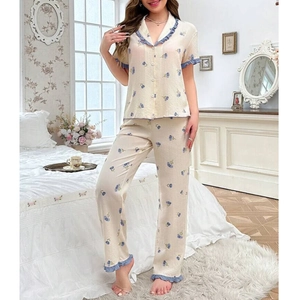Detailed close-up of blue floral print pajamas with ruffled lace trim on the collar and sleeves