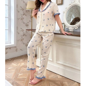 Detail of blue tulip floral print on breathable cream-colored loungewear set for women