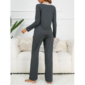 Women grey ribbed lounge set with lace trim shown from the back in cozy home setting