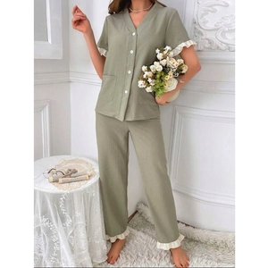 Detail view of v-neck short sleeve pajama set with white ruffle trim in grass green color