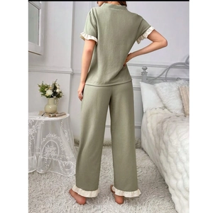 Rear view of light green women's v-neck pajama set with white ruffled trim and soft fabric