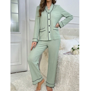 Detail of light green waffle knit pajamas with V-neck button top and contrast piping