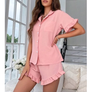 Close-up of pink pajama sleeve and hem featuring sweet ruffle trim and soft texture