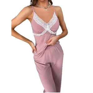 Pink two-piece loungewear set featuring a lace V-neck camisole and ribbed knit trousers