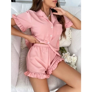 Close-up of pink short-sleeve pajama set with lapel collar and ruffle trim details