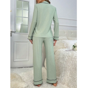 Women's two-piece sage green pajama set with waffle texture and black piping trim