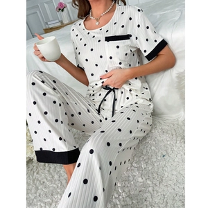 Detailed view of the ribbed fabric and contrast black piping on polka dot pajamas