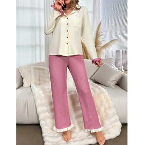 Detail of soft jacquard pajamas showing ruffled cuffs and pink contrast button design