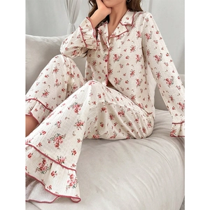 Detail view of floral pajama set featuring ruffled cuffs and delicate rose patterns