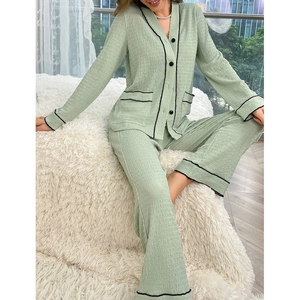 Women's light green pajama set with black contrast piping and soft crinkle texture