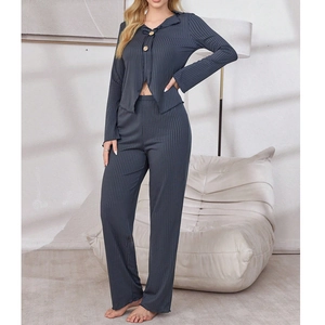 Detail of grey ribbed pajama set showing wooden buttons and soft breathable fabric texture