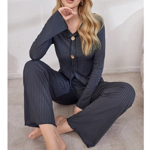 Detail of ribbed pajama fabric with stylish V-neck and decorative wooden buttons