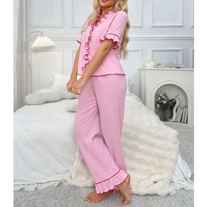 Women's pink pajama set featuring short sleeve V-neck top with red ruffled edges