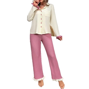 Women's pajama set featuring white waffle knit top with pink trim and matching pants