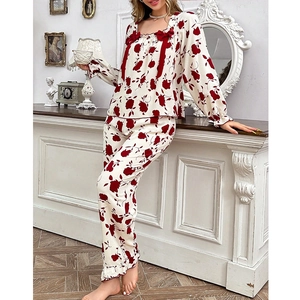 Detail of floral lounge set featuring red rose prints, square neck and bow accents