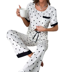 Women's white polka dot pajama set with short sleeve top and striped texture pants