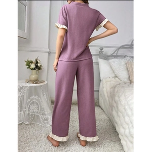 Lilac pajama set with short sleeves, long pants and cream ruffled trim shown from behind