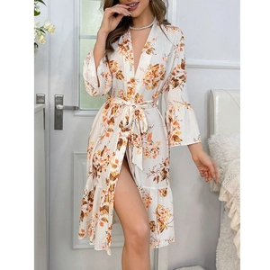 Detail of floral printed robe with tie-waist, flared sleeves and ruffled hem design