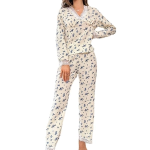 Women's two-piece floral pajama set with lace trim and long pants in beige and blue