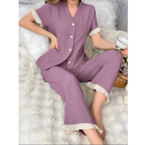 Detail showing the textured pucker fabric and white ruffle trim on the V-neck pajama set