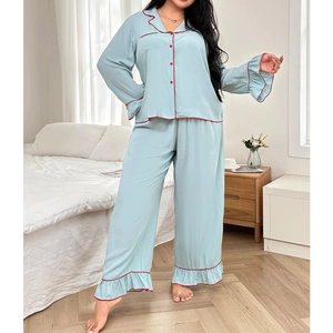 Light blue two-piece pajama set with long sleeves, red trim, and elegant ruffle details