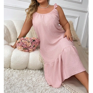 Detail of pink textured sleeveless sleepwear dress with ruffle hem on a plush sofa
