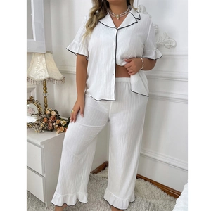 Elegant white short sleeve pajama set with black piping and textured vertical pleats