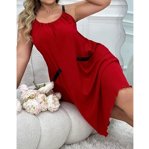 Red knit sleeveless nightdress with thin black straps and pockets on white sofa