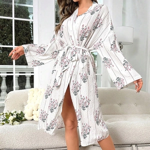 Close-up of white floral robe featuring V-neckline and tie-waist in lightweight fabric