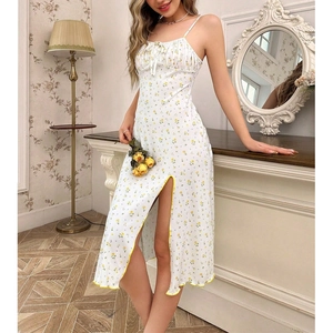 Detail shot of white floral dress showing the side slit and yellow scalloped trim