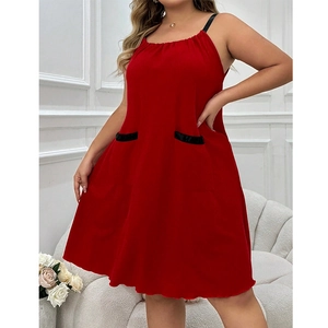 Close-up of red plus size slip dress featuring black straps and decorative front pockets