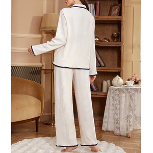 Women's cream waffle knit pajamas set with dark blue scalloped trim and wide-leg pants