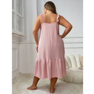 Pink textured ruffle strap sleepwear dress for women in a minimalist indoor setting