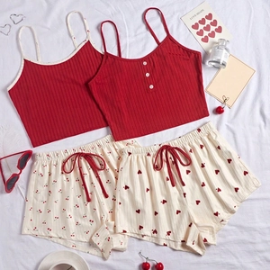 Flat lay of ribbed tank tops and patterned shorts with heart and cherry prints