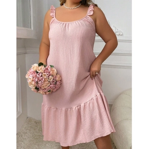 Detail of light pink plus size slip nightgown featuring ruffled edges and textured fabric