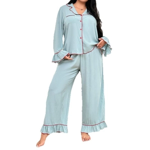 Relaxed fit women's pajama set featuring contrast red piping and elegant ruffled cuffs